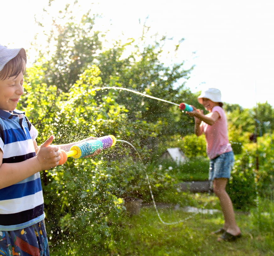 Teenagers playing with water pistols