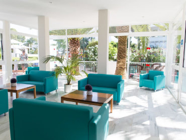 Lounge with armchairs and chairs overlooking the gardens