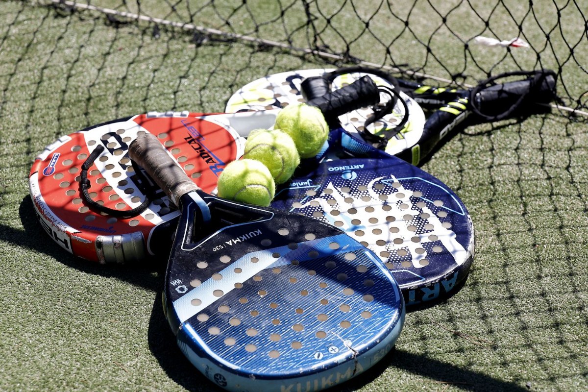 Paddle rackets and balls on grass