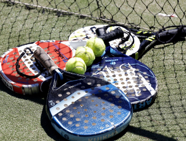 Paddle rackets and balls on grass