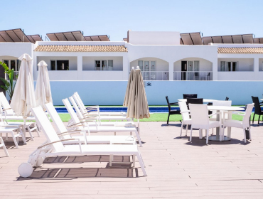 Solarium area with sun loungers, parasols, tables and chairs