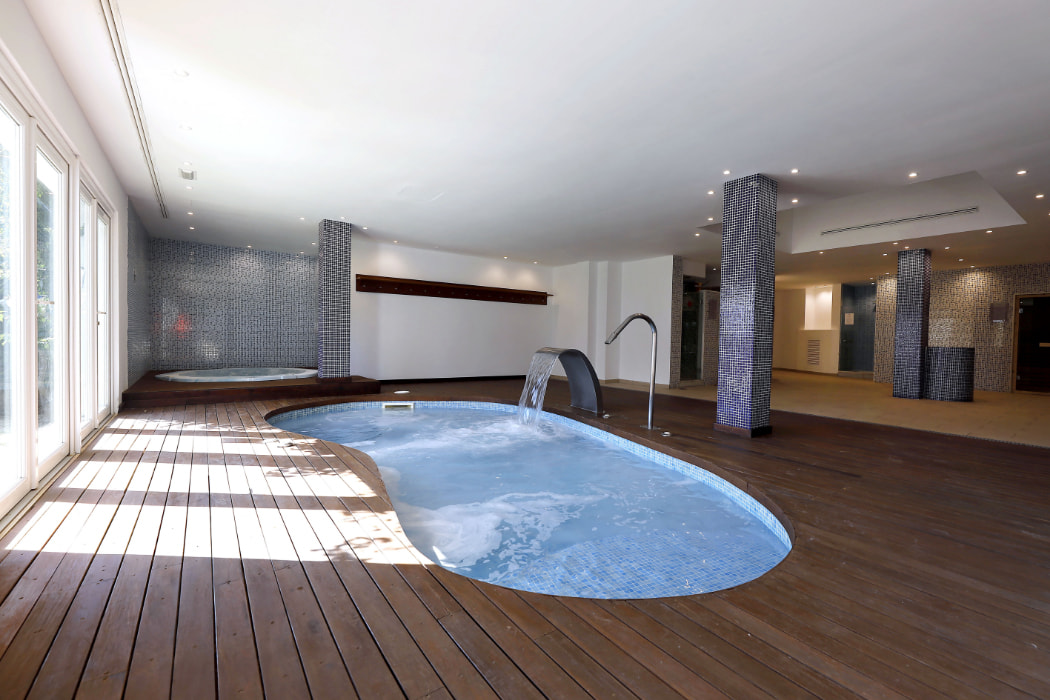 Heated indoor swimming pool on wooden decking