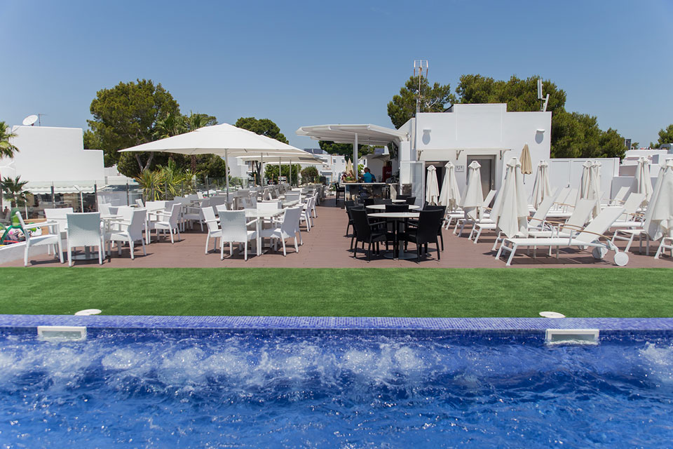 Hammocks, chairs, tables and umbrellas in the chill out area.