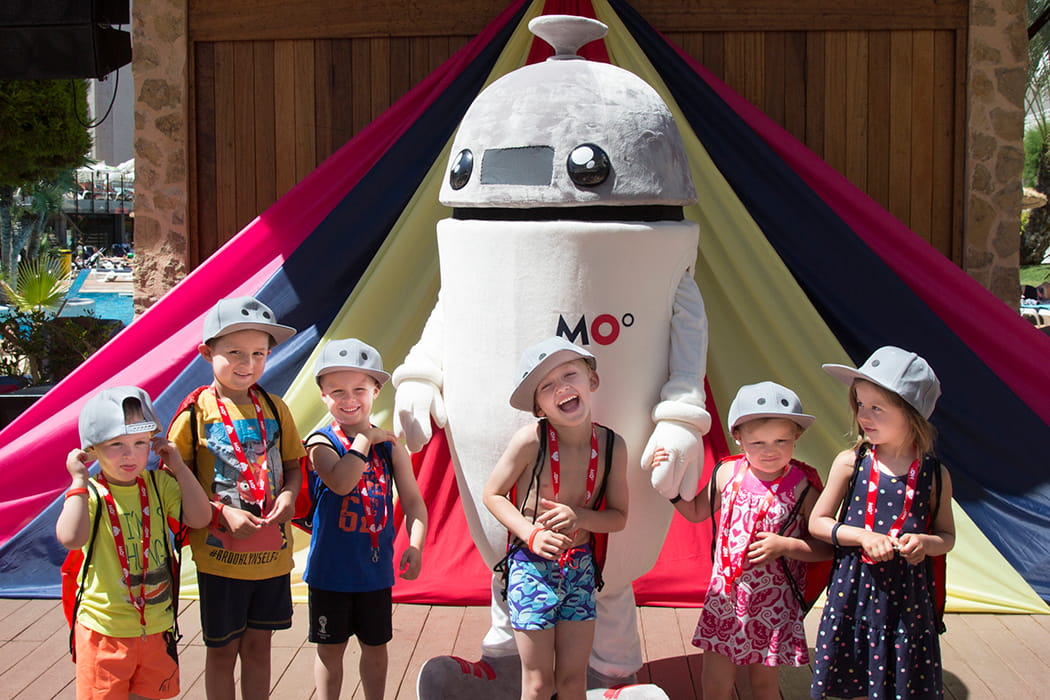 Mascot of Hotel Club Es Talaial with a group of small children